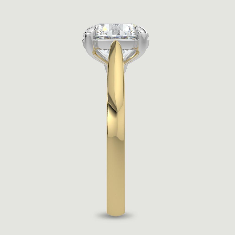 An 18ct yellow gold single stone diamond engagement ring, set with a lab-grown round brilliant diamond held in a platinum four claw setting. Viewed from the edge.