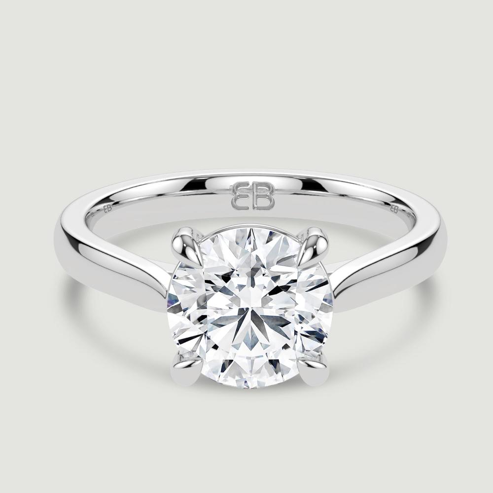 A platinum single stone diamond engagement ring, set with a lab-grown round brilliant diamond held in a four claw setting. Viewed from above.