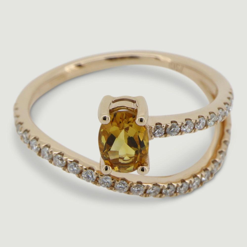 Rose gold two row swirl ring set with an oval citrine and micro-pavé set band - view from an angle