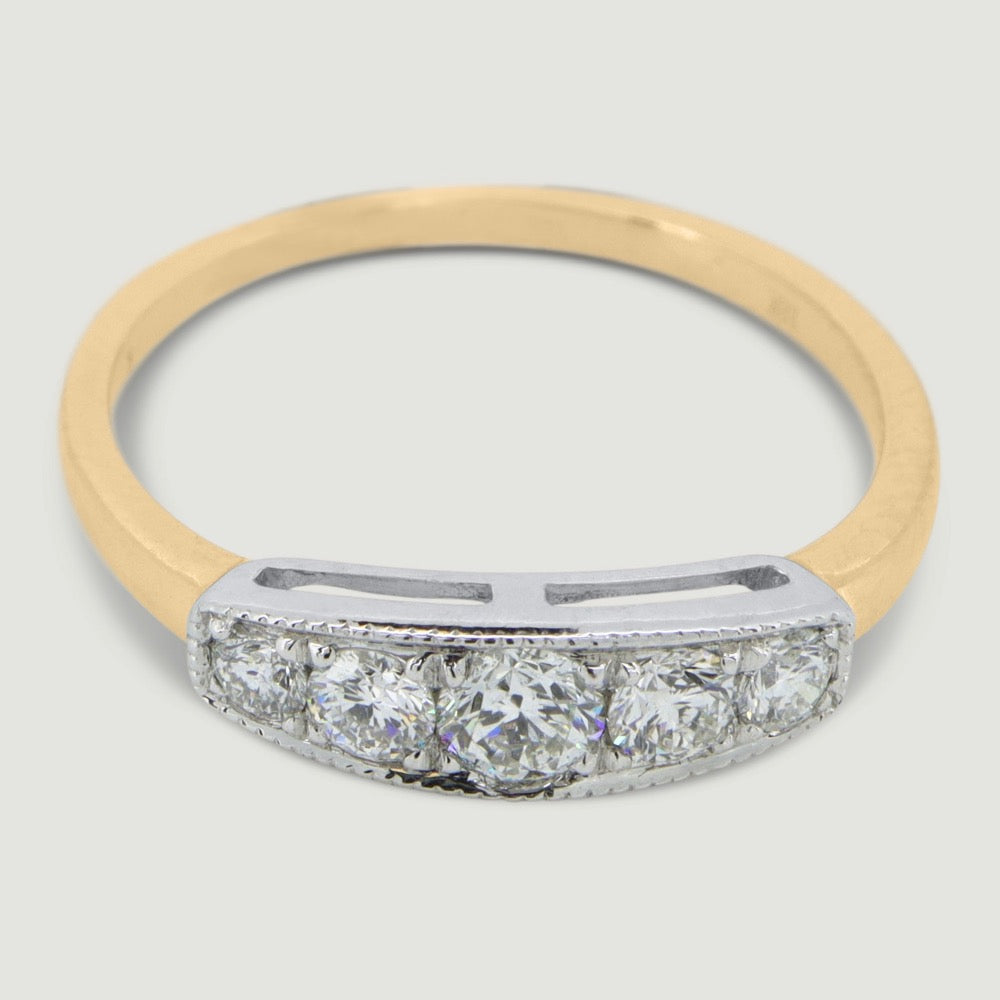 Five stone vintage style ring the round diamonds are grain set in a box with a mill grained edge the band of the ring is a little wide and plain - view from an angle
