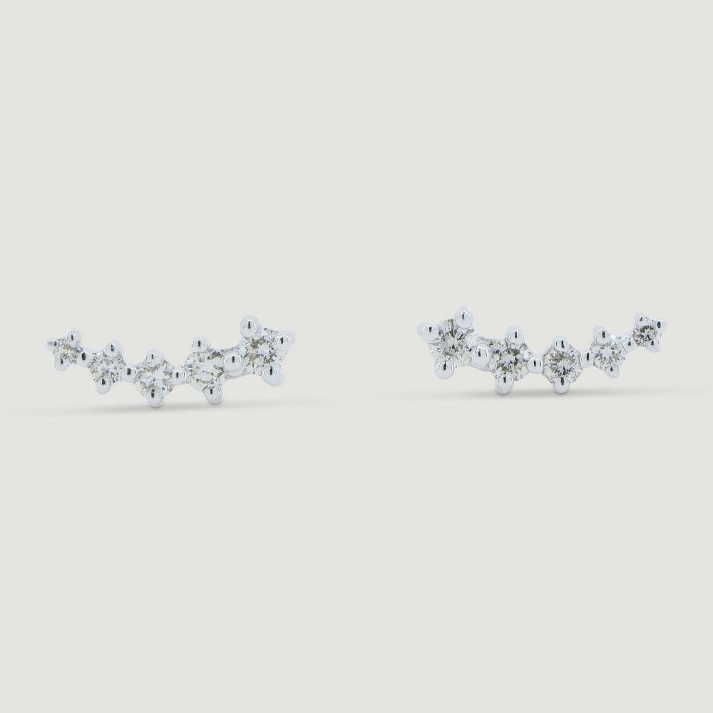 Five graduating round diamonds claw set in a curved white gold setting