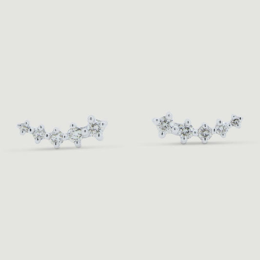 Five graduating round diamonds claw set in a curved white gold setting