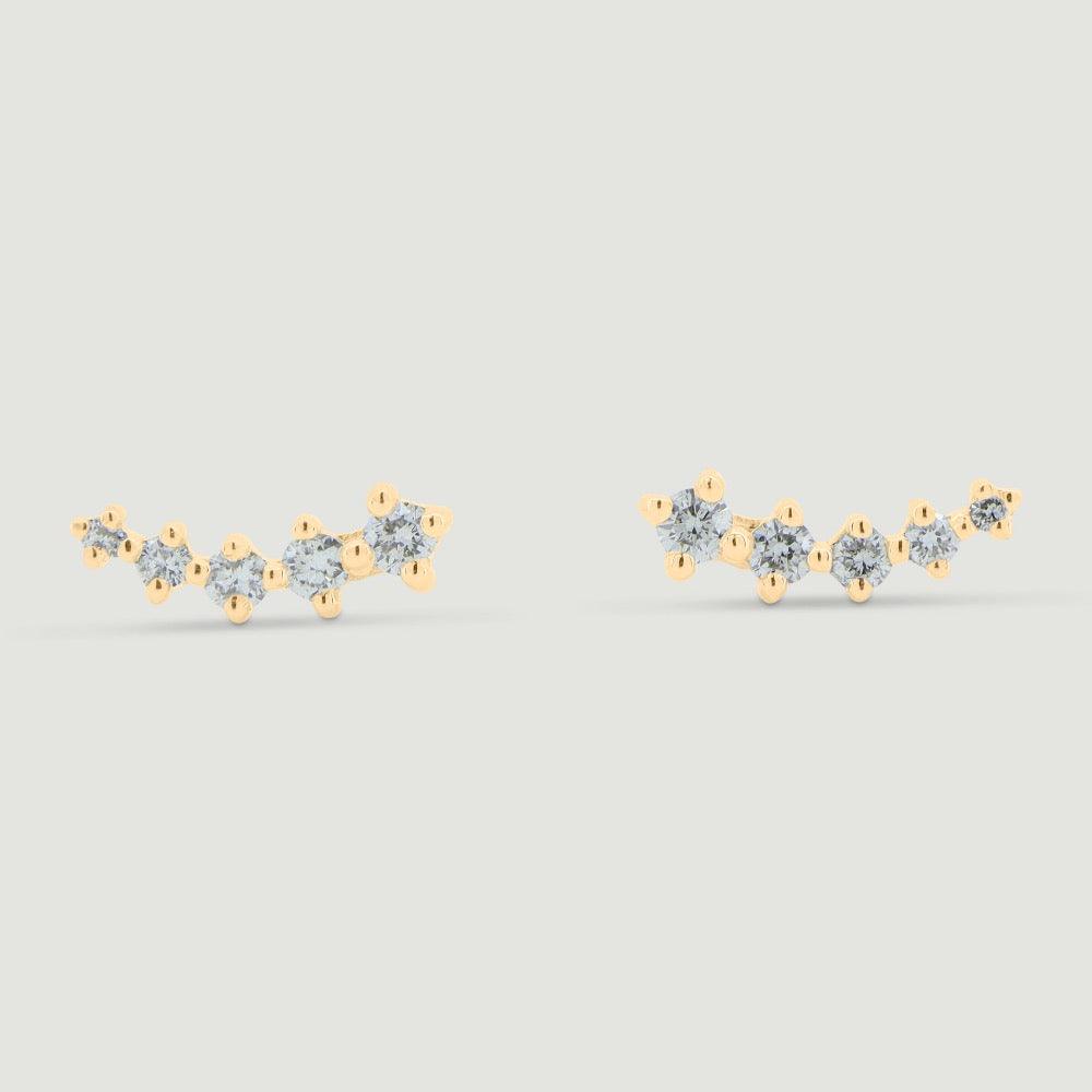 Five graduating round diamonds claw set in a curved yellow gold setting