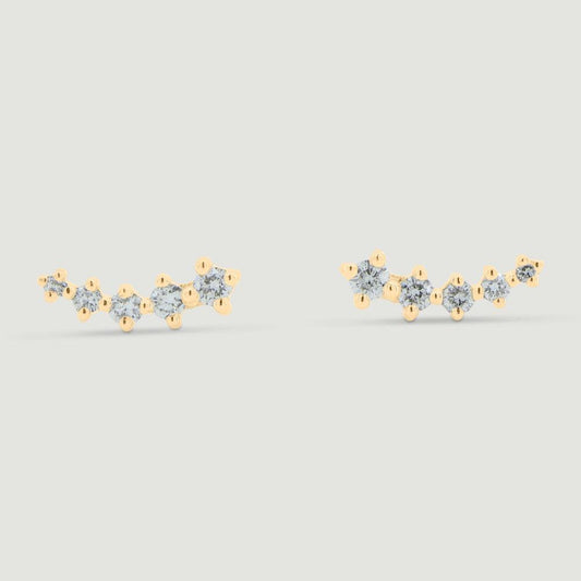 Five graduating round diamonds claw set in a curved yellow gold setting