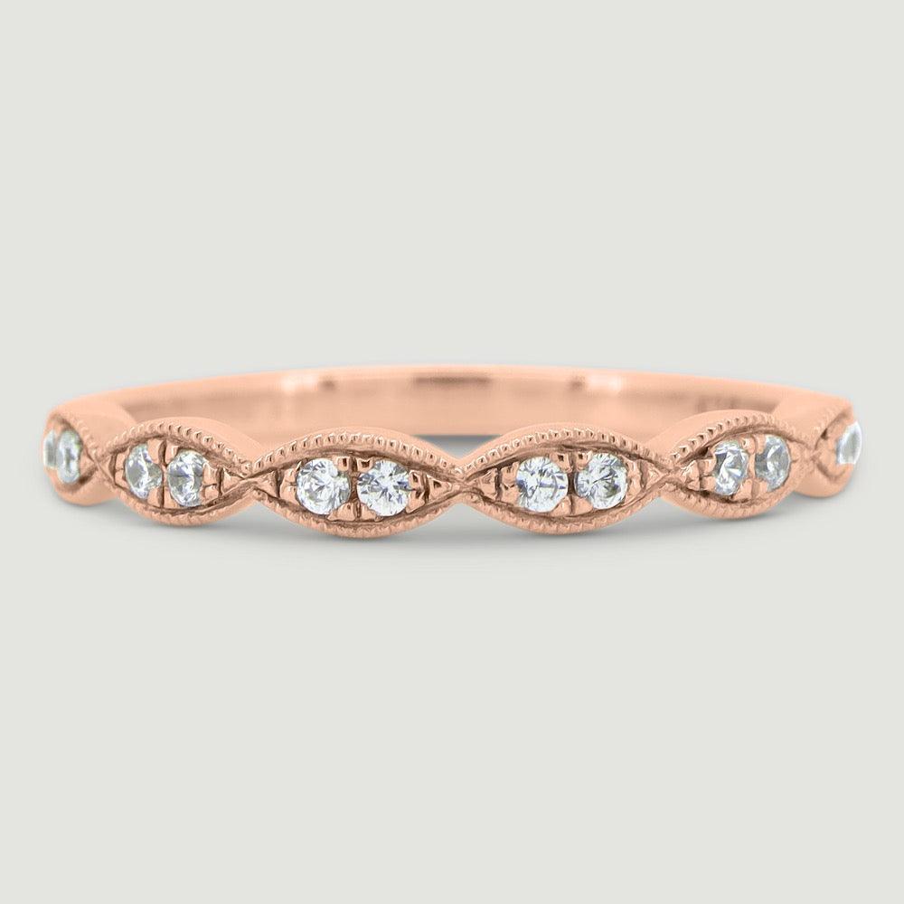 Fancy diamond ring set with 2 stones grain set into each marquise shaped section 18RG