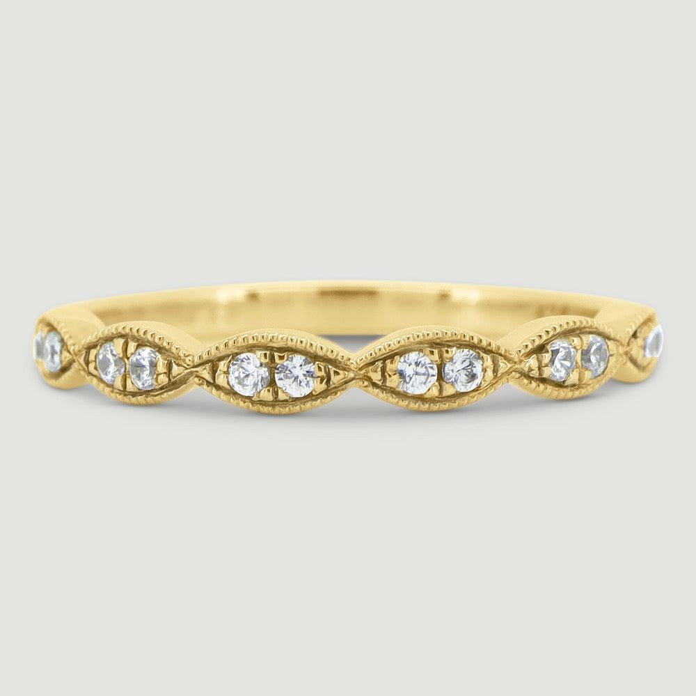 Fancy diamond ring set with 2 stones grain set into each marquise shaped section 18YG