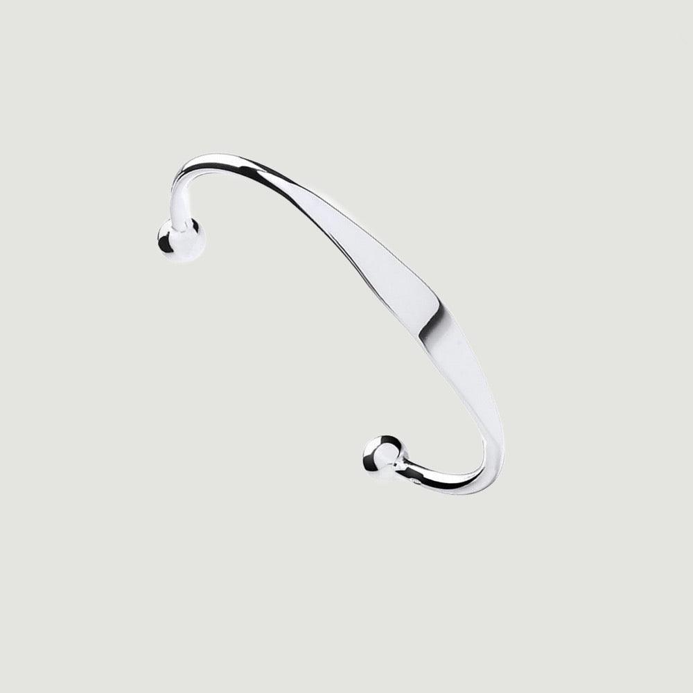Baby’s silver torque bangle also known as a ball bangle, the solid bangle is made from a round wire that has an id plate in its centre with a ball on the two ends