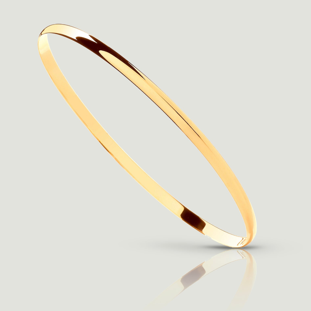 A close-up image of a 9ct yellow gold D-shaped bangle, 3mm wide. The bangle is shown balancing diagonally on one side, revealing a smooth, flat, interior surface for comfortable wear. Its smooth, tactile exterior is gently curved, providing a sleek and stylish look. This elegant piece of jewellery is a timeless addition to any collection, perfect for adding sophistication to any ensemble.