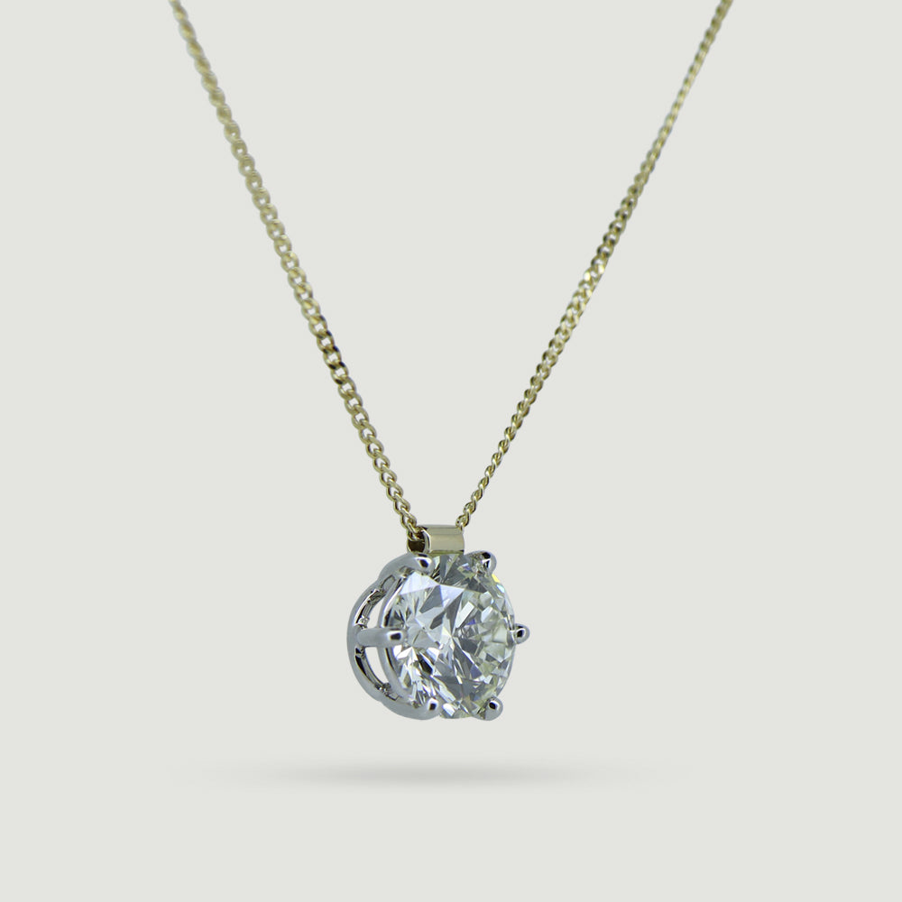 6 claw solitaire diamond pendant in 18ct yellow gold and platinum from angle