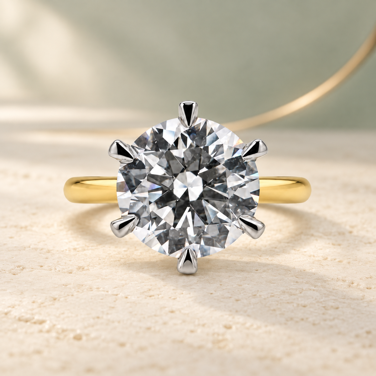 Yellow gold and platinum solitaire engagement ring with a natural round diamond in talon claws.