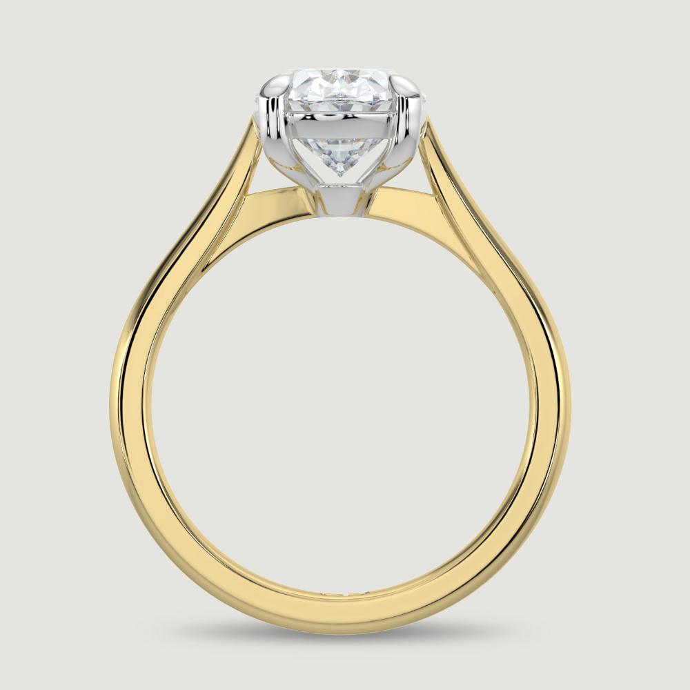 An 18ct yellow gold single stone diamond engagement ring, set with a lab-grown oval shape diamond held in a platinum four claw setting. Viewed from the side.