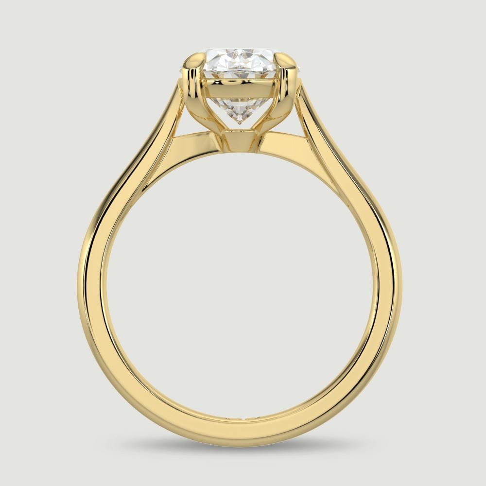 An 18ct yellow gold single stone diamond engagement ring, set with a lab-grown oval shape diamond held in a four claw setting. Viewed from the side.