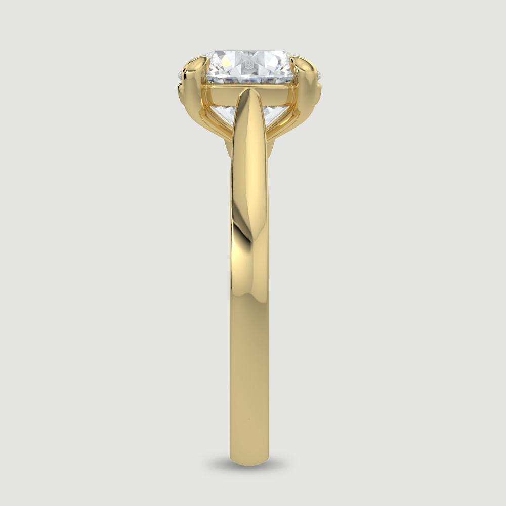 An 18ct yellow gold single stone diamond engagement ring, set with a lab-grown round brilliant diamond held in a four claw setting. Viewed from the edge.