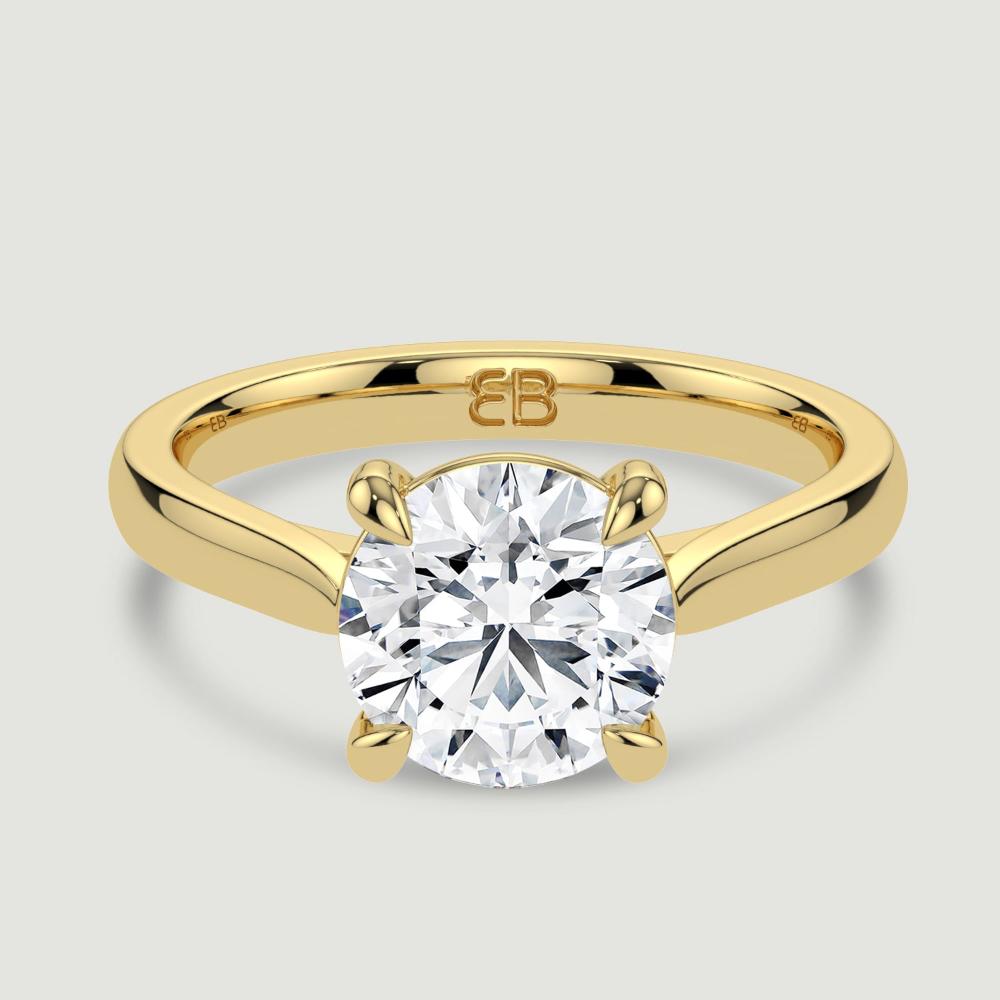 An 18ct yellow gold single stone diamond engagement ring, set with a lab-grown round brilliant diamond held in a four claw setting. Viewed from above.