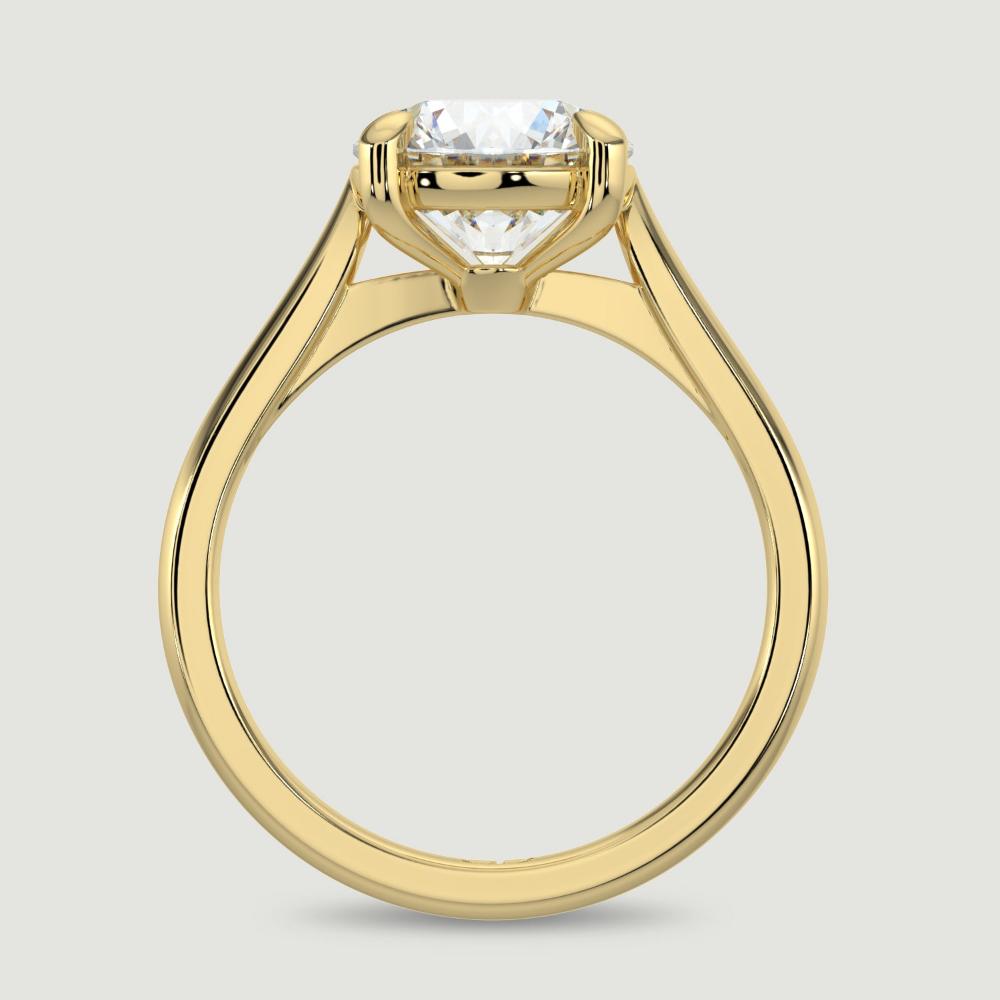 An 18ct yellow gold single stone diamond engagement ring, set with a lab-grown round brilliant diamond held in a four claw setting. Viewed from the side.
