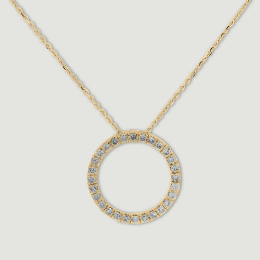 Yellow gold diamond pendant, claw set with small round brilliant diamonds forming a circle 15mm in diameter, hanging on a fine chain - view from the front