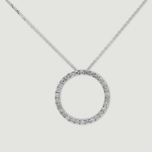 White gold diamond pendant, claw set with small round brilliant diamonds forming a circle 18mm in diameter, hanging on a fine chain - view from the front