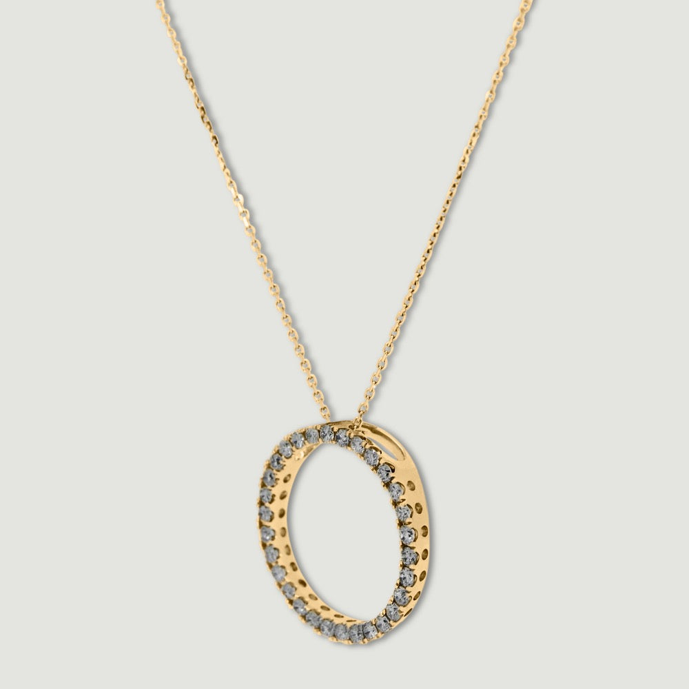 Yellow gold diamond pendant, claw set with small round brilliant diamonds forming a circle 18mm in diameter, hanging on a fine chain - view from an angle