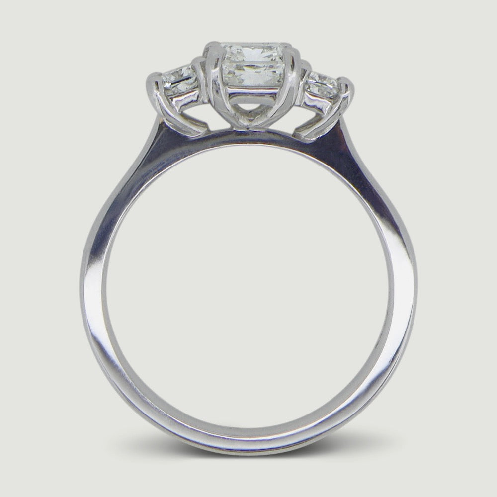 Platinum trilogy diamond engagement ring, claw set with three cushion shaped diamonds - view from the side