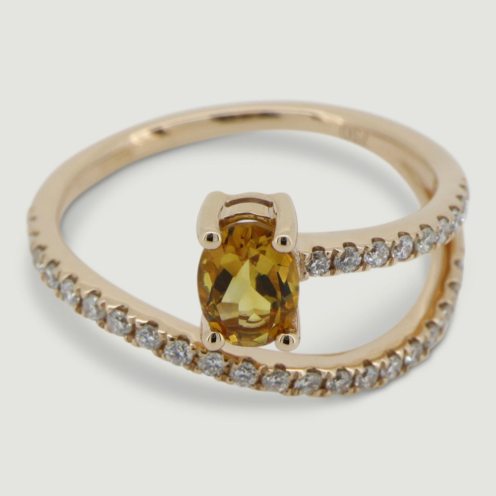 Rose gold two row swirl ring set with an oval citrine and micro-pavé set band - view from an angle