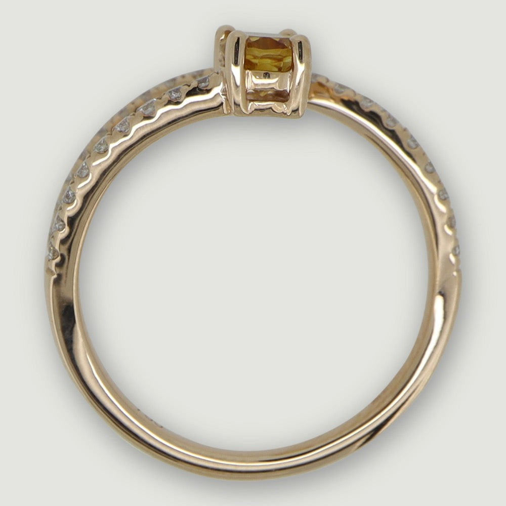 Rose gold two row swirl ring set with an oval citrine and micro-pavé set band - view from the side