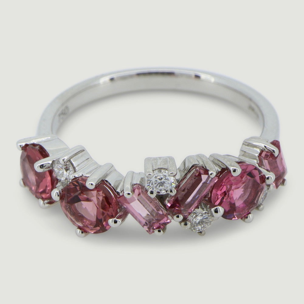 Pink tourmaline and diamond dress ring, stones scattered in a seemingly random patter - view from an angle