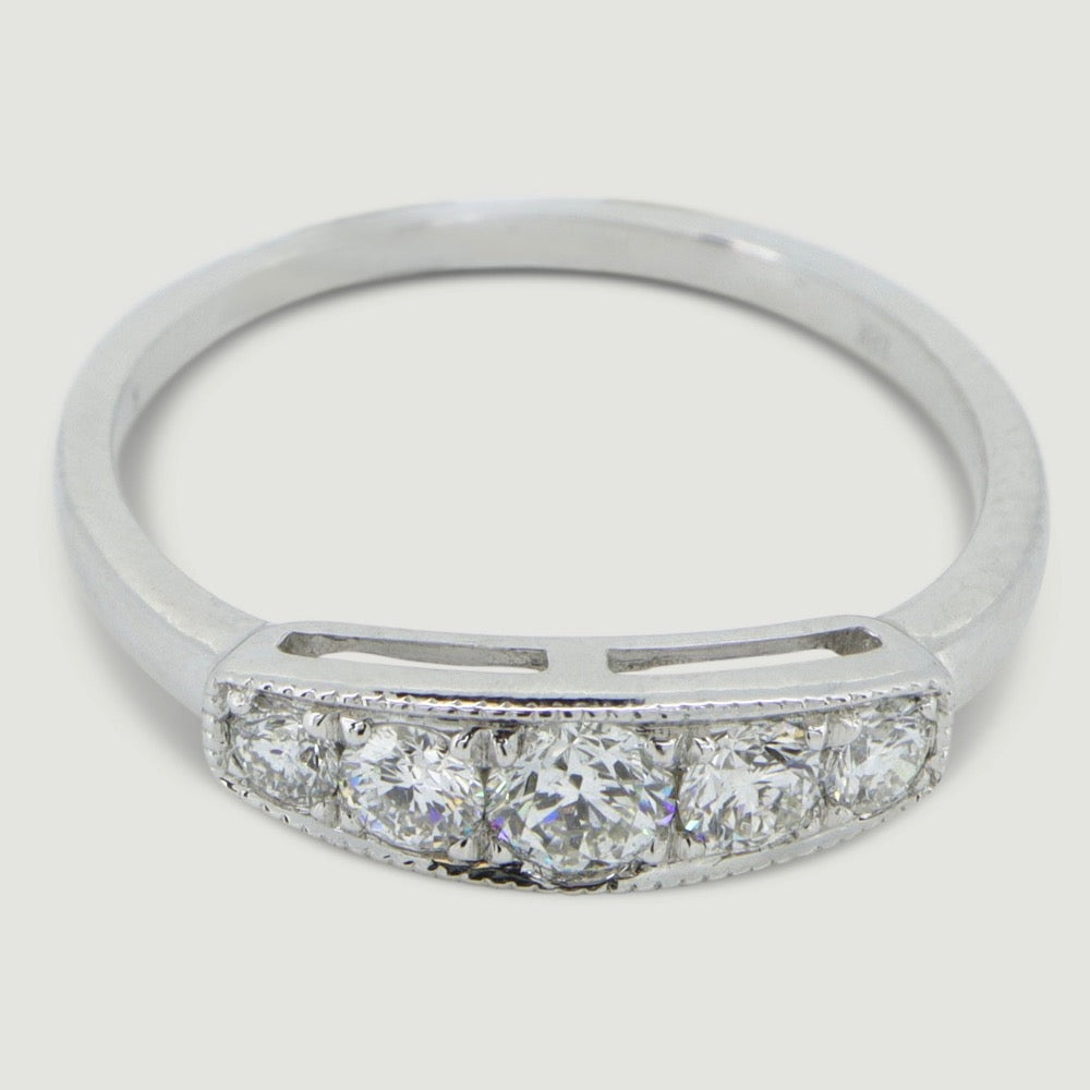 Five stone vintage style ring the round diamonds are grain set in a box with a mill grained edge the band of the ring is a little wide and plain - view from an angle