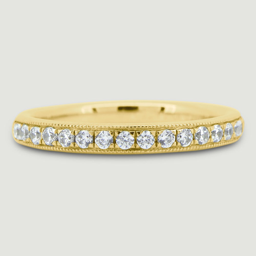Court shaped 2.5mm band gain set with round brilliant diamonds with a beaded edge 18YG