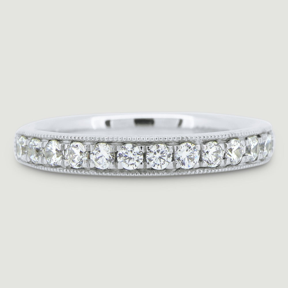 3mm court shape ring grain set with round diamonds and a beaded edge 18WG