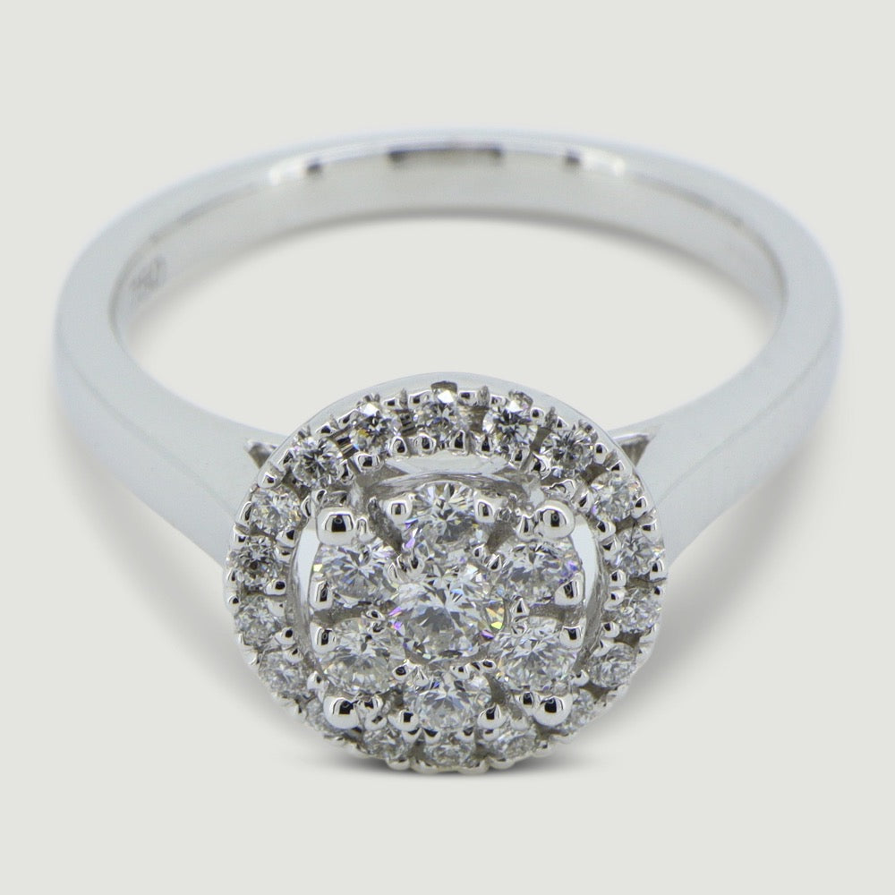 18ct white gold halo style ring the micro-pavé set halo encompasses a cluster of seven round diamonds - view from an angle