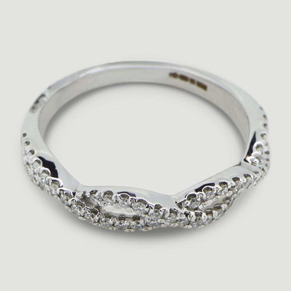two rows of round diamonds micro pave set into a plaited design. ring in platinum viewed from an angle