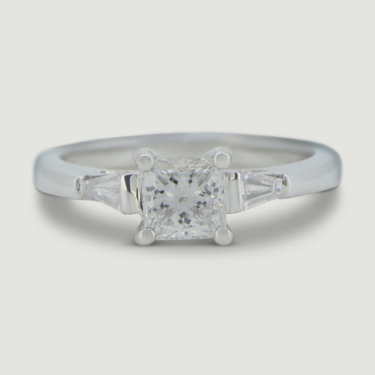 Platinum three stone ring set with a princess cut centre stone and tapered baguette cut diamonds on the sides - view from the top