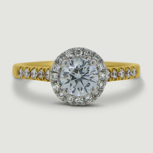 Gold and Platinum halo engagement Ring. The main Round diamond is held in a four claws and is surrounded by a mircro-pavé set halo of diamonds with diamonds micro-pavé set half way down the shoulders - view from the top
