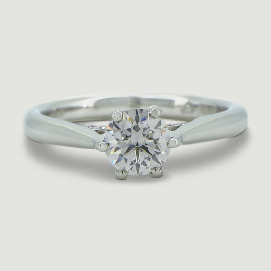 Platinum solitaire engagement Ring. The main Round diamond is held in a six claw crucible setting that sits atop a grain set diamond bridge - view from the top