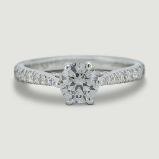 Platinum solitaire engagement Ring. The main Round diamond is held in a six claw crucible setting that sits atop a grain set diamond bridge, the shoulders of the ring are micro-pavé set half way around with round diamonds - view from the top