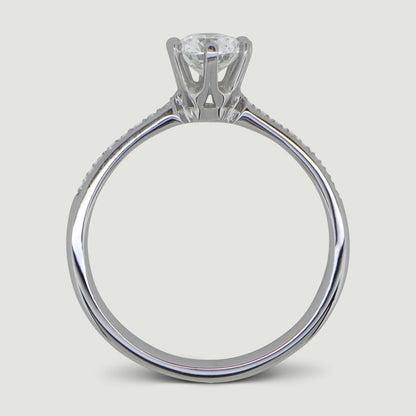 Platinum solitaire engagement Ring. The main Round diamond is held in a six claw Tiffany-style setting with diamonds grain set half way down the shoulders - view from the side