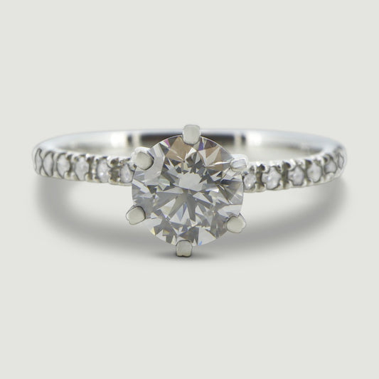 Platinum solitaire engagement Ring. The main Round diamond is held in a six claw Tiffany-style setting with diamonds micro-pavé set half way down the shoulders - view from the top