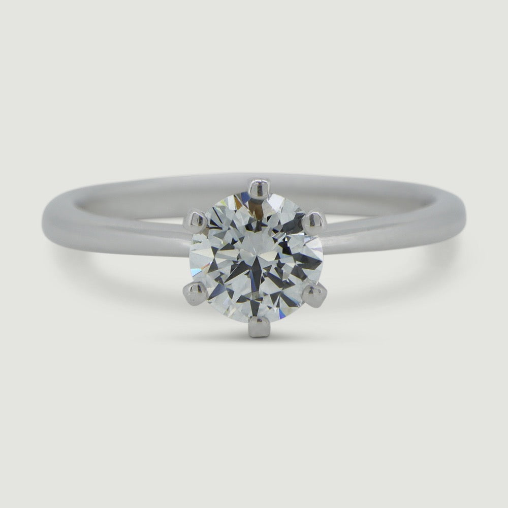 Solitaire six claw engagement ring in platinum, the ring has a delicate tapering band that draws focus onto the main diamond - view from the top