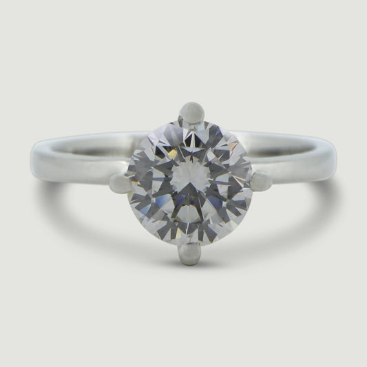 Platinum solitaire engagement Ring. The main Round diamond is held in a four claw compass setting- view from the top