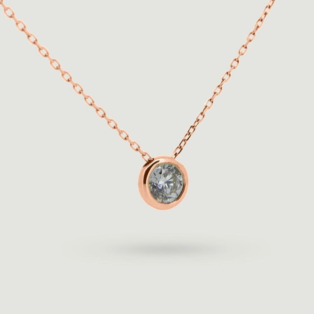 Rose gold Rub over round diamond pendant sliding on a chain - view from an angle