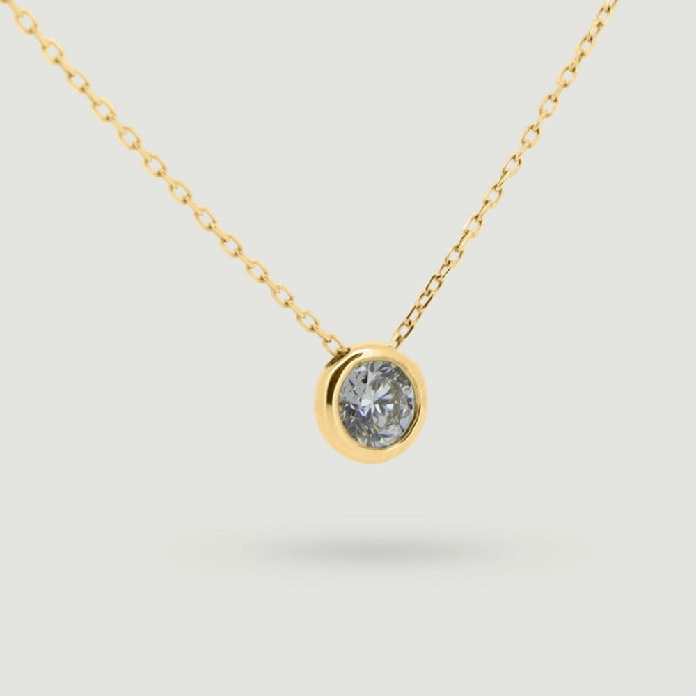 Yellow gold Rub over round diamond pendant sliding on a chain - view from an angle